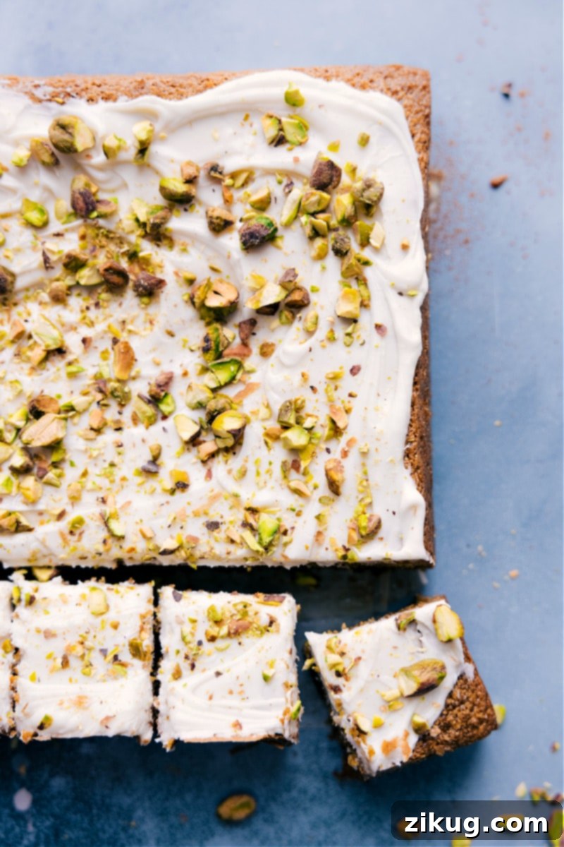 A stunning and healthy Pistachio Cake by ChelseasMessyApron, sweet, moist, and perfectly ready for any occasion. Overhead shot of the finished Pistachio Cake, frosted and garnished, perfectly ready for serving.