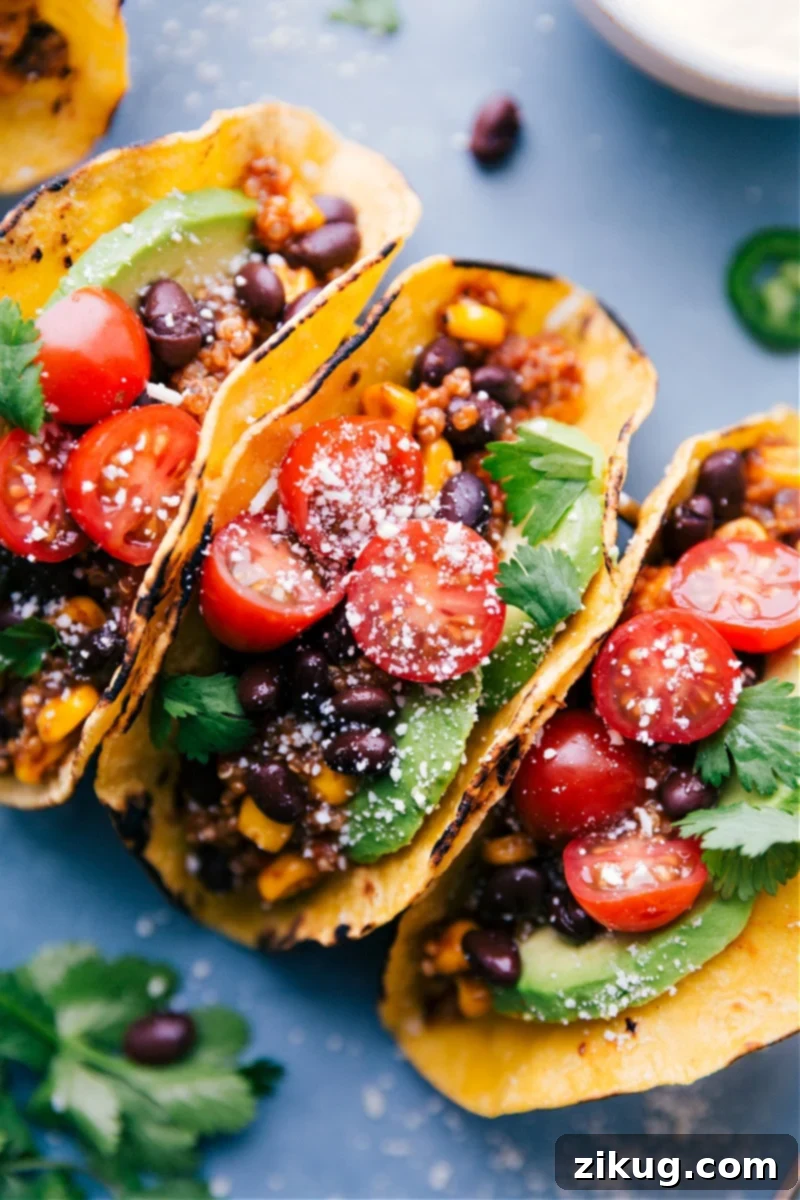 Flavor-packed, meatless Quinoa Tacos are incredibly easy; just dump everything into the slow cooker and let it work its magic! Serve on warmed tortillas with your favorite taco toppings. Recipe via chelseasmessyapron #dinner #quick #easy #simple #delicious #healthy #vegetarian #quinoa #tacos Up-close overhead image highlighting the delicious texture and toppings of Quinoa Tacos.