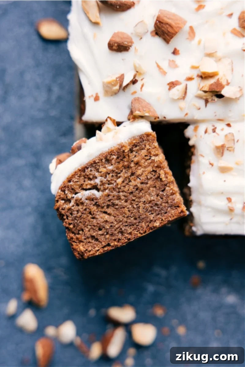 Moist, Dense, and Perfectly Sweet Healthy Banana Cake with Cream Cheese Frosting A perfectly baked, healthy banana cake slice, topped with optional cream cheese frosting and a banana chip.