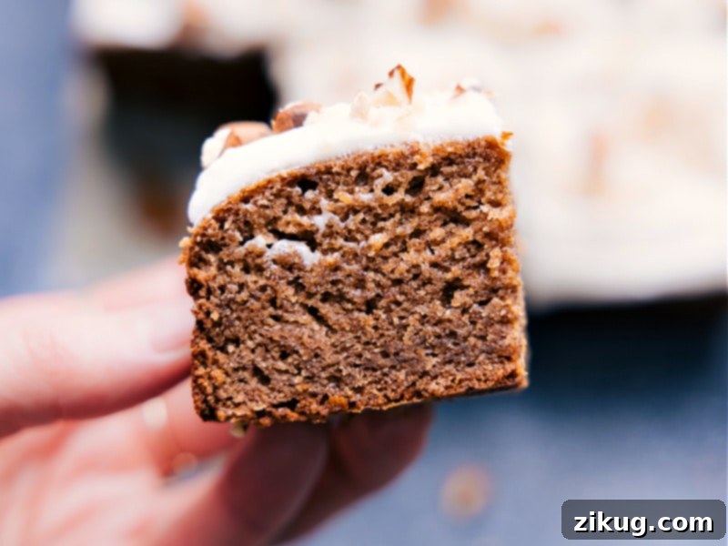 Close-up of Moist Healthy Banana Cake Slice Detailed close-up view of a slice of Healthy Banana Cake, showing the moist texture and topping.