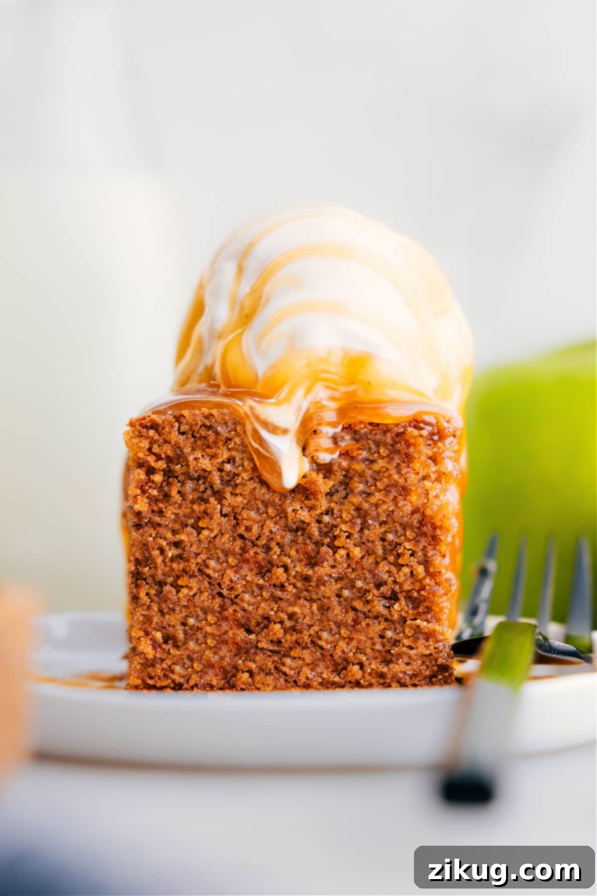 Serve Healthy Apple Cake on a plate topped with ice cream, showcasing its moist texture.