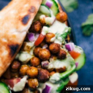 Spiced Tikka Wrap 3 Close-up view of a vegetarian tikka masala wrap, showing the filling of spiced chickpeas, fresh greens, and sauce.