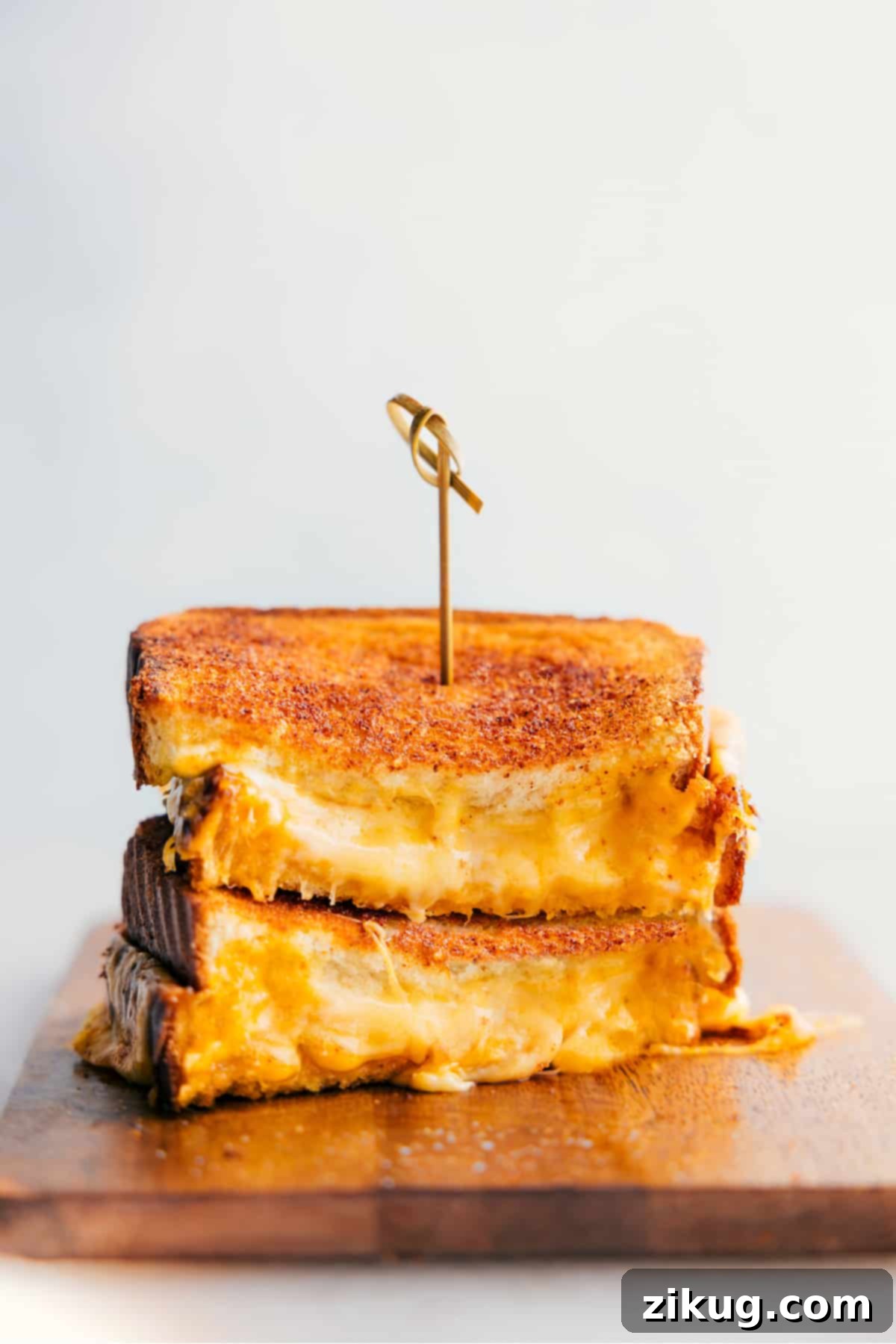 Grilled Cheese stacked on top of each other showing the cheesy center, with golden-brown bread.
