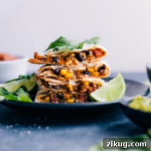 A perfectly cooked Black Bean Quesadilla, sliced into triangles and ready to be served.