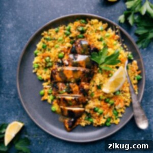 Moroccan Chicken with couscous, garnished with fresh herbs