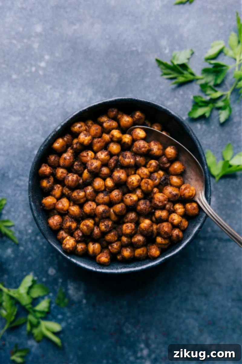 A bowl filled with freshly cooked, generously seasoned crispy Air Fryer Chickpeas, ready to be enjoyed as a healthy snack or versatile meal addition.