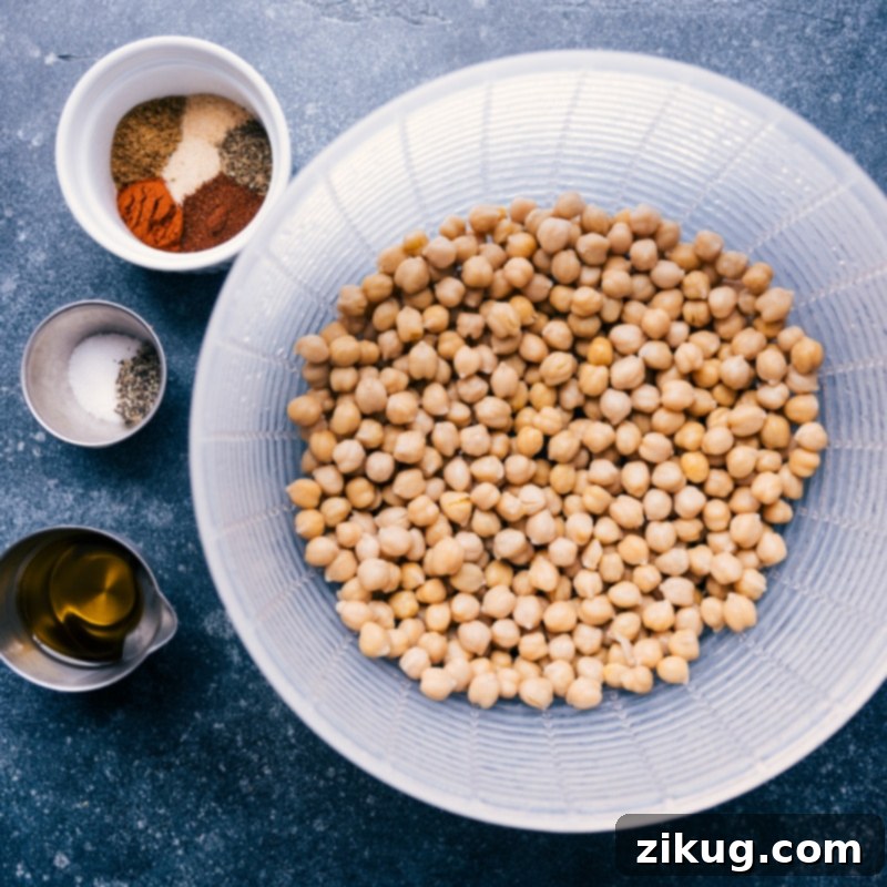 A collage of ingredients used for Air Fryer Chickpeas: canned chickpeas, olive oil, and various spices like chili powder, cumin, and paprika, laid out on a clean surface.