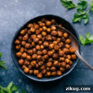 Crispy Air Fryer Chickpeas in a serving bowl, garnished with fresh herbs.
