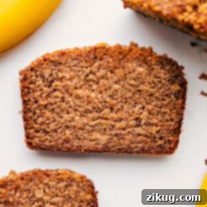 A beautifully baked loaf of Greek Yogurt Banana Bread, ready to be sliced and served.