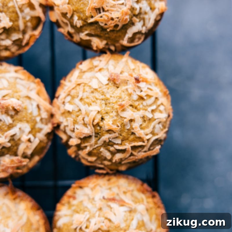 The most delicious Pistachio Muffins cooling, ready for a delightful breakfast or snack. This recipe is brightly flavored, moist, tender, and perfectly spiced. An overhead, close-up view of freshly baked Pistachio Muffins cooling on a wire rack, showcasing their golden-brown tops and moist interior.