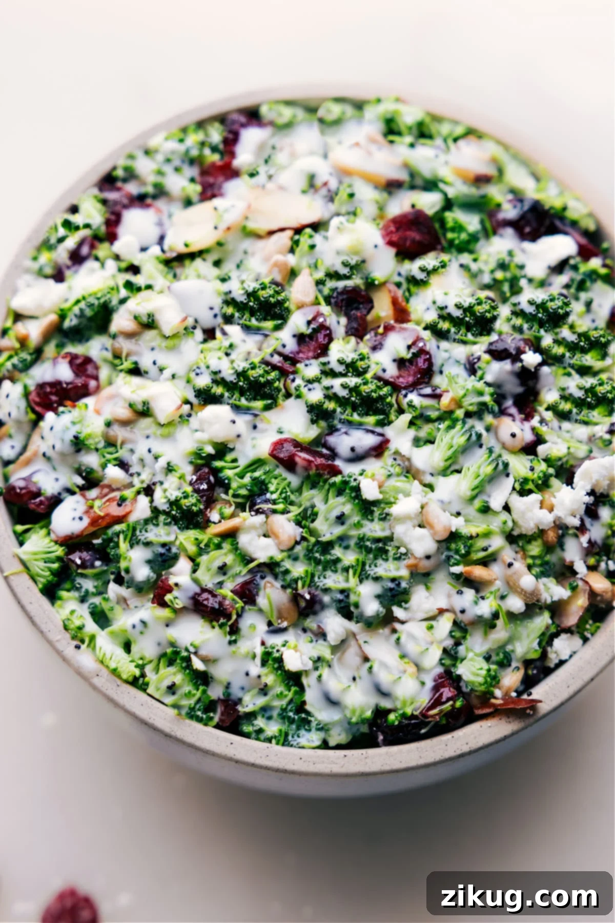 Lemon Poppy Seed Broccoli Salad – A Fresh and Flavorful Dish A large bowl of fresh Lemon Poppy Seed Broccoli Salad, showcasing the vibrant green broccoli, red cranberries, and golden nuts, all coated in a creamy dressing.