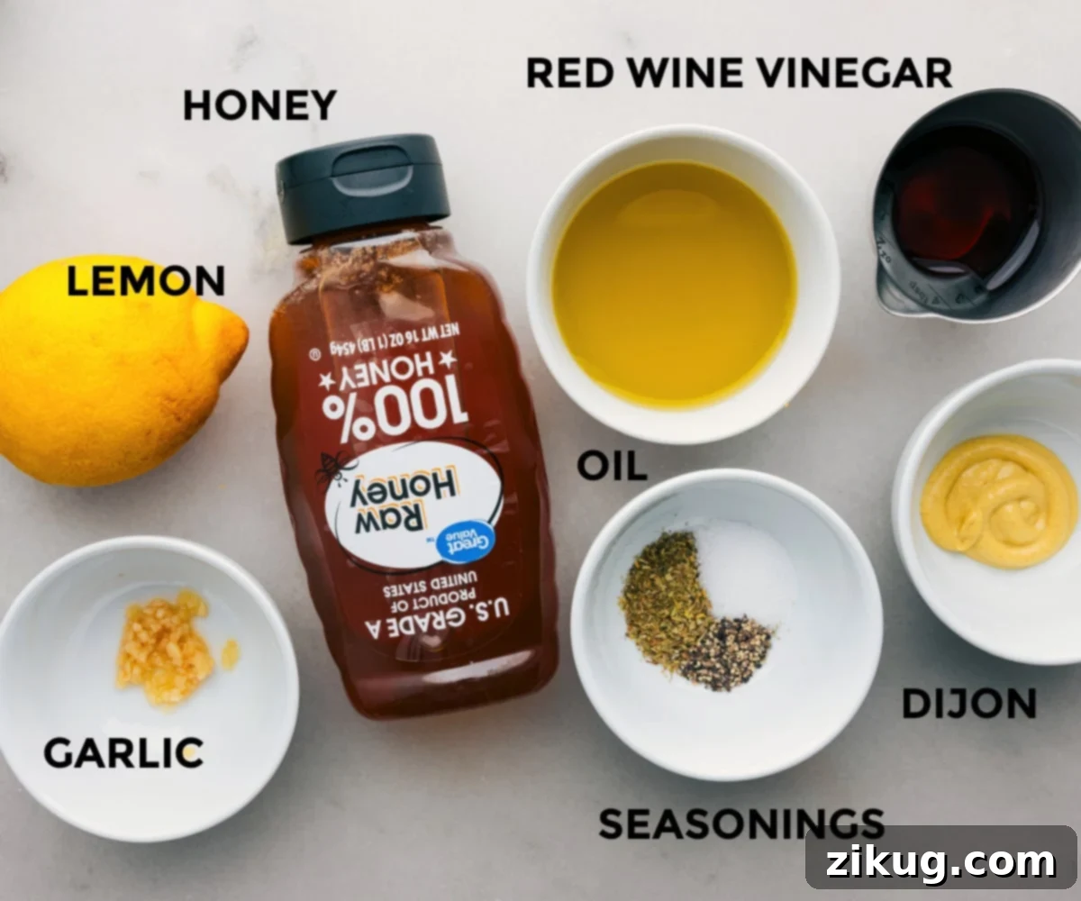 All the ingredients for the zesty lemon dressing arranged on a surface.