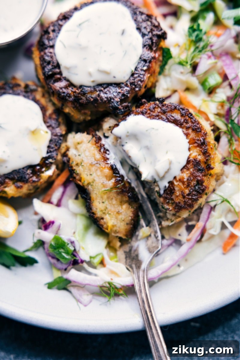 Overhead image of crispy Tuna Patties served on a bed of fresh coleslaw with a generous dollop of homemade tartar sauce
