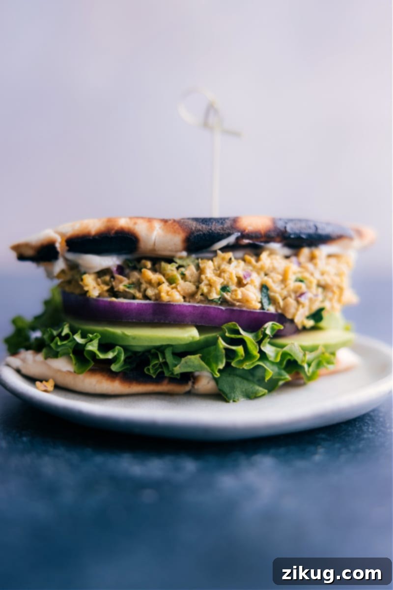 Overhead image of a vibrant Curried Chickpea Salad in a bowl, garnished with fresh herbs