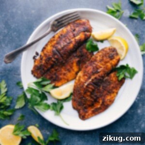 Delicious Air Fryer Tilapia: A quick and healthy recipe. Close-up of a perfectly cooked Air Fryer Tilapia fillet, golden brown and flaky, ready to be served.