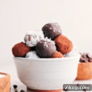 A close-up of a finished chocolate truffle, dusted with cocoa powder, in a recipe card setting.