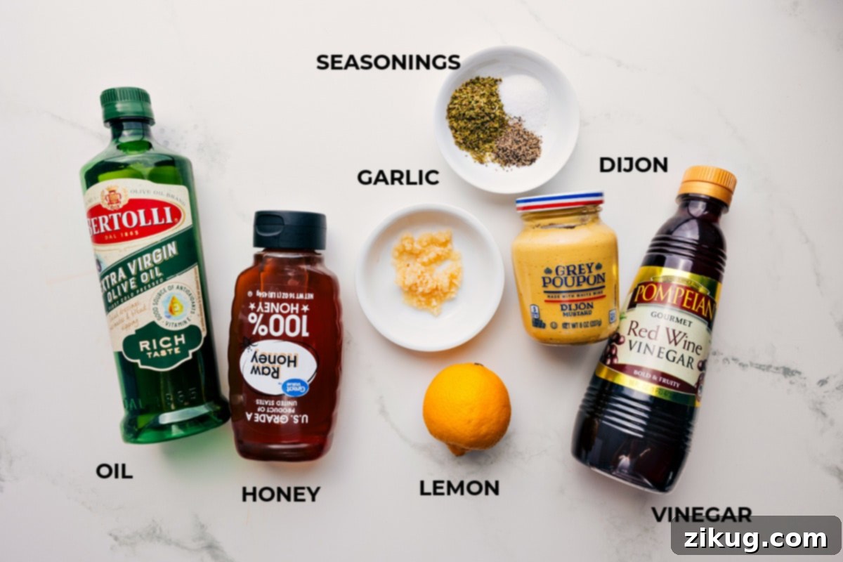 Ingredients for homemade Greek salad dressing, including olive oil, fresh lemon, honey, Dijon mustard, minced garlic, dried oregano, and red wine vinegar, arranged for easy preparation.