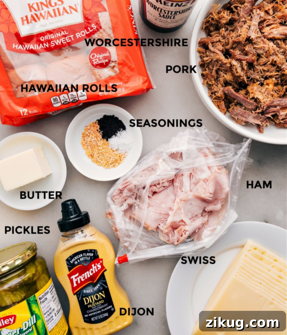 All the fresh ingredients prepped out for easy assembly of these delicious Cuban Sliders, including Hawaiian rolls, shredded pork, ham, Swiss cheese, and dill pickles.
