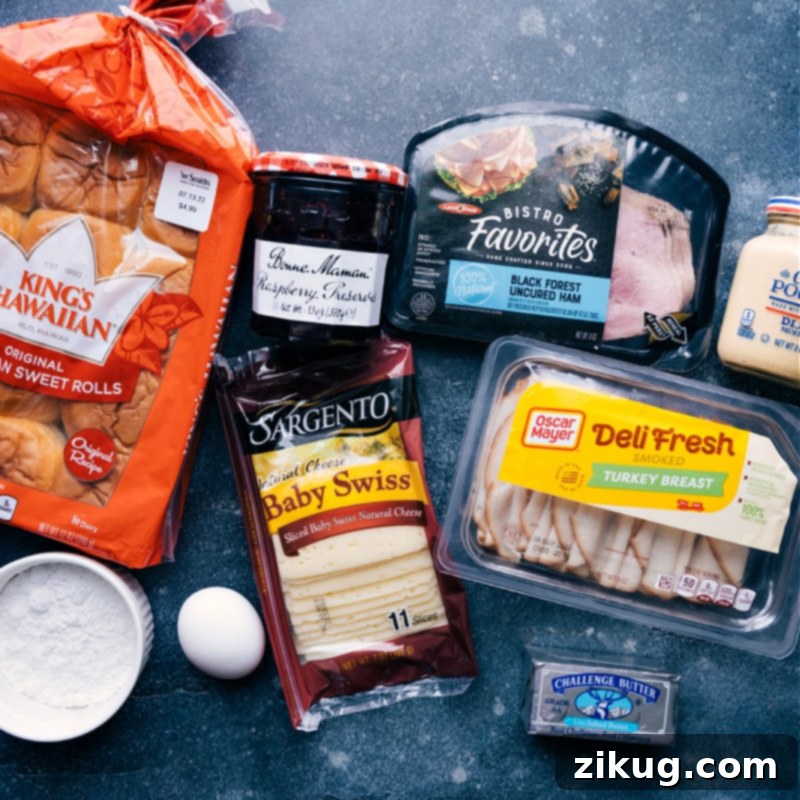 Fresh Ingredients for Homemade Monte Cristo Sliders A vibrant display of fresh ingredients for Monte Cristo Sliders including Hawaiian rolls, ham, turkey, Swiss cheese, and Dijon mustard.