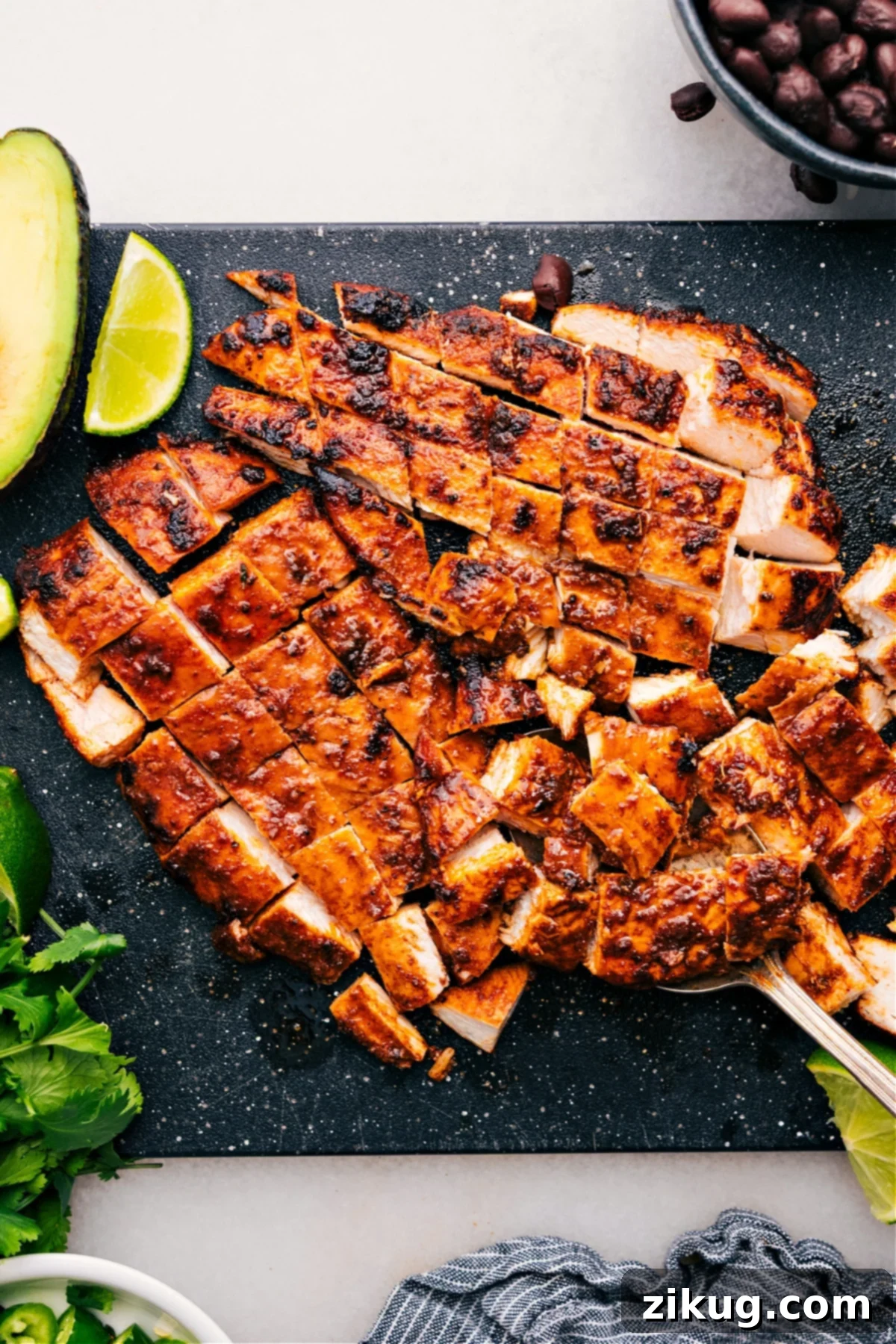 The meat fresh off the grill, expertly chopped into uniform pieces, ready to serve as the star of delicious tacos, bowls, or salads, showcasing its perfect char and tender texture.