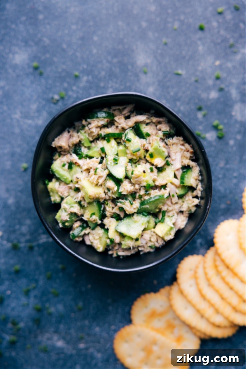 Overhead image of a beautifully presented tuna salad with no mayo, garnished with fresh herbs and served in a stylish bowl