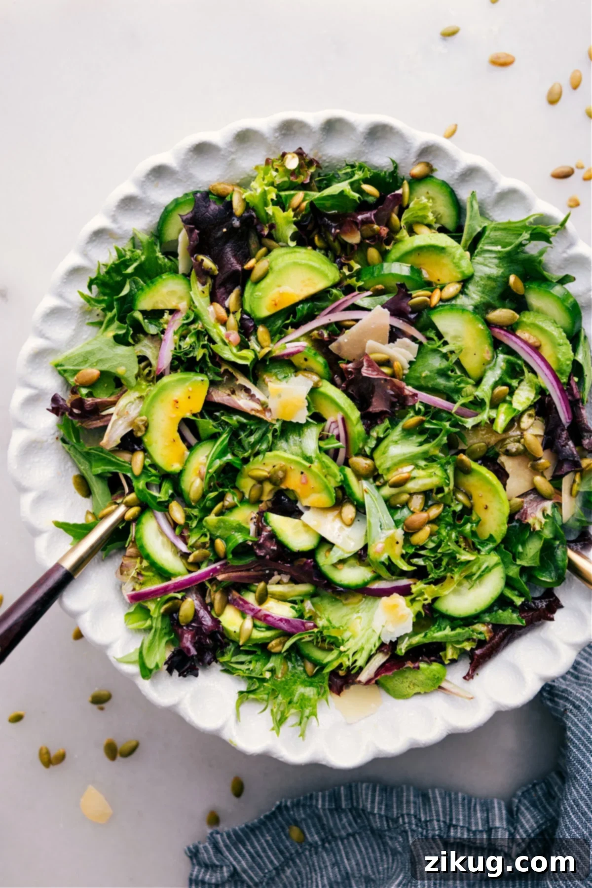 Favorite Everyday Salad Recipe in a bowl with dressing poured over. A vibrant, fresh salad ready to be enjoyed.