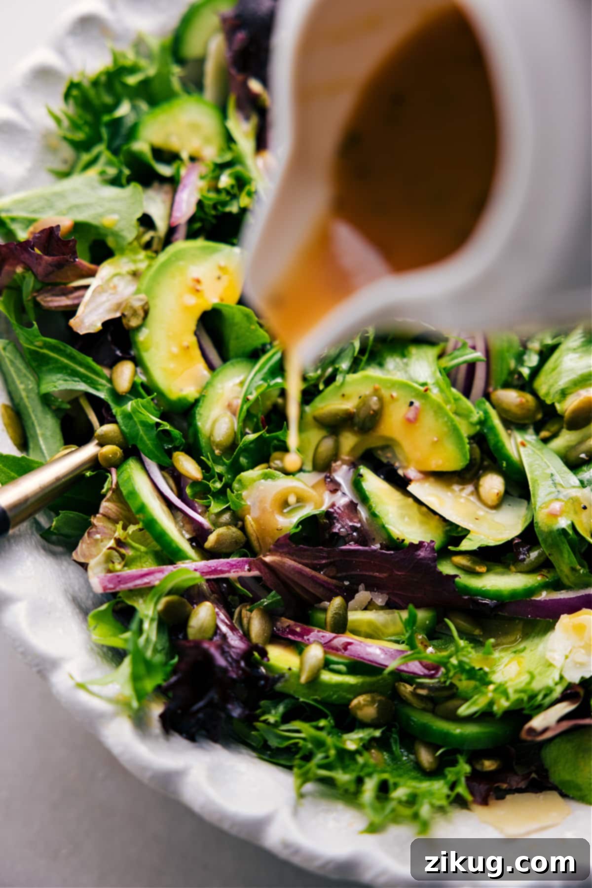 Drizzling dressing over this favorite everyday salad. The final touch for a perfectly prepared salad.
