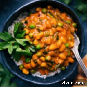 A serving of the quick Vegan Curry in a bowl, garnished with fresh herbs, ready to be enjoyed.