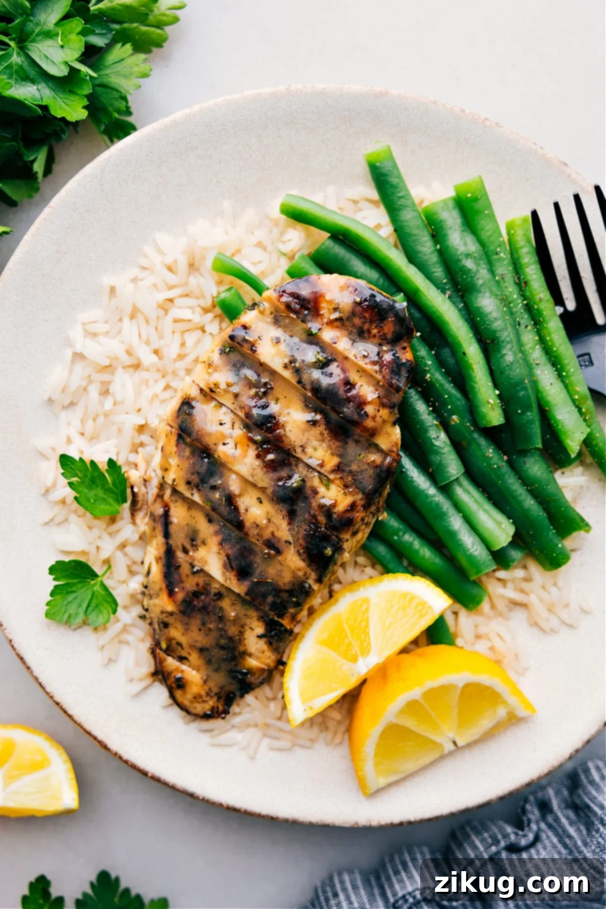Delicious Italian Chicken Marinade Recipe for Grilling Perfectly grilled Italian Chicken Marinade served on a bed of fluffy rice with crisp green beans, a truly appetizing and healthy meal.