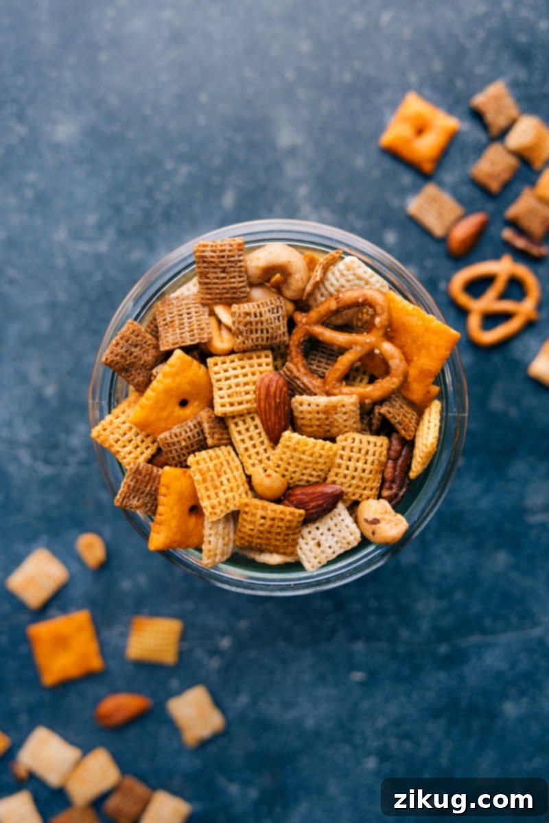 Generous bowl of homemade Chex Mix, perfect for sharing at parties or enjoying as a family snack. #partyfoodideas #snackbowl #deliciouschexmix Overhead view of Chex Mix in a large bowl, ready for serving