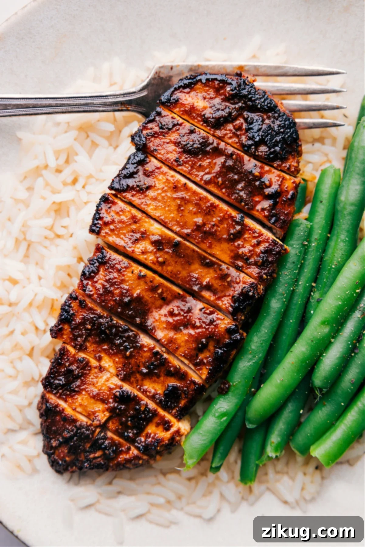 Blackened Chicken Dinner Idea Easy Blackened Chicken recipe served over a bed of fluffy rice with crisp green beans on the side, showcasing a delicious and healthy meal.