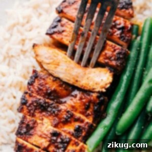 The easy blackened chicken recipe with a fork picking up a piece, highlighting its tender and flavorful appearance.