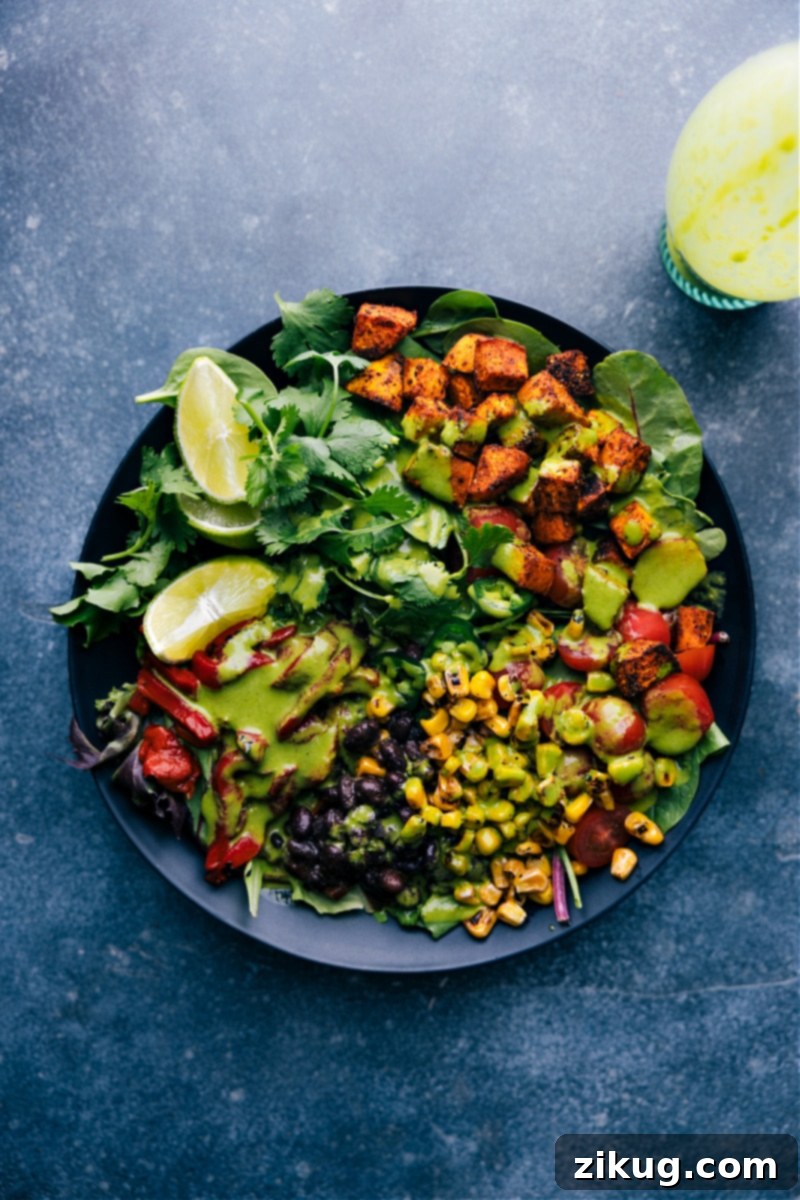 This bright and vibrant Cilantro Lime Dressing owes its flavor to fresh lime juice and citrusy cilantro. Plus it's easy to prepare -- simply throw everything into a blender and let it whirl! This naturally vegan, dairy-free, and gluten-free Cilantro Lime Dressing checks all the nutrition boxes. Recipe via ChelseasMessyApron.com #cilantrolime #cilantro #lime #citrusy #glutenfree #vegan #dairyfree #salads Overhead view of a salad with Cilantro Lime Dressing added