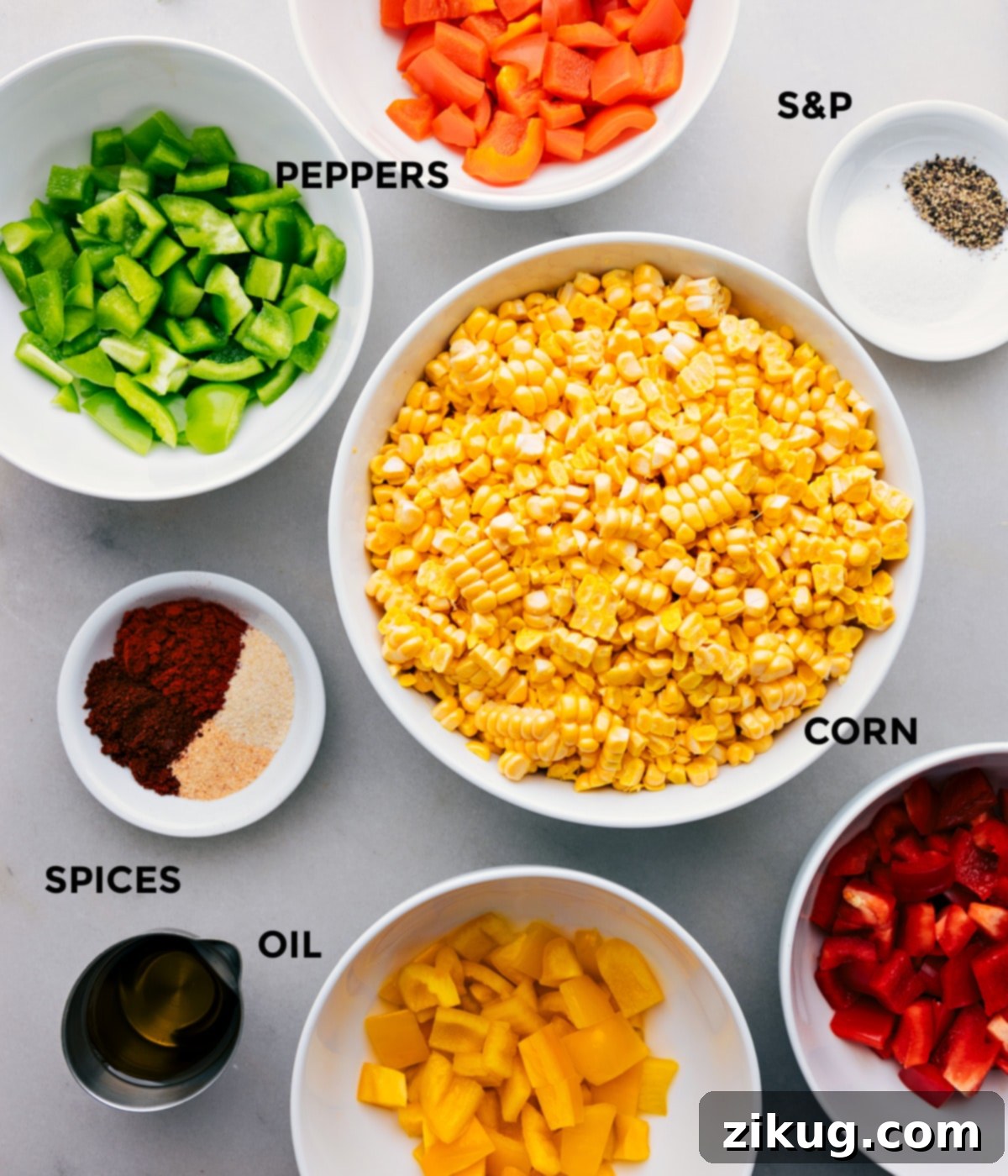 Ingredients In This Roasted Corn Recipe All the fresh ingredients for roasted corn and peppers including corn on the cob, colorful bell peppers, olive oil, and various spices, prepped and laid out for easy assembly.