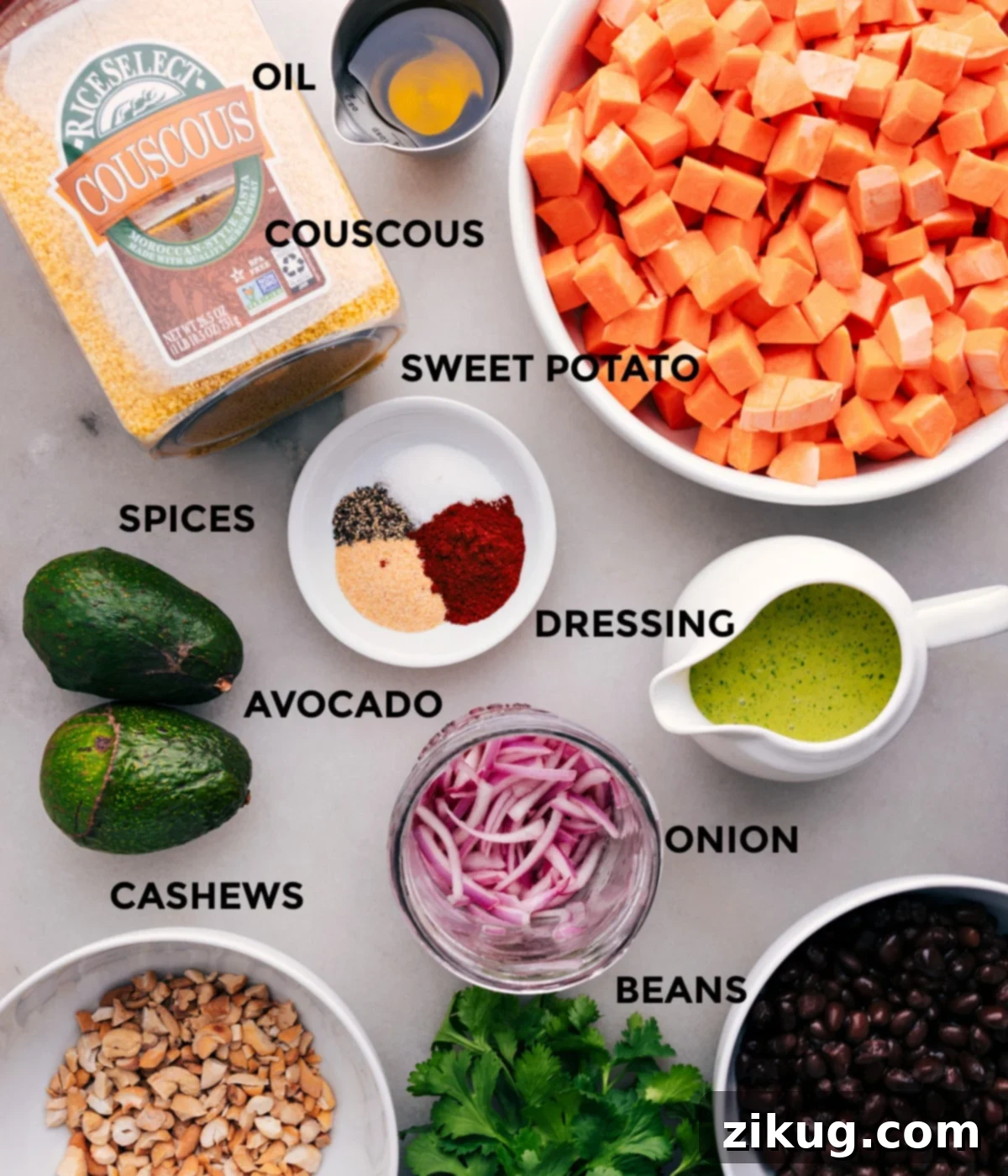 Ingredients In Sweet Potato Black Bean Salad All the fresh ingredients laid out for preparation, including diced sweet potatoes, cooked couscous, rinsed black beans, ripe avocado, chopped cashews, and a vibrant cilantro dressing, ready for the Sweet Potato Black Bean Salad.
