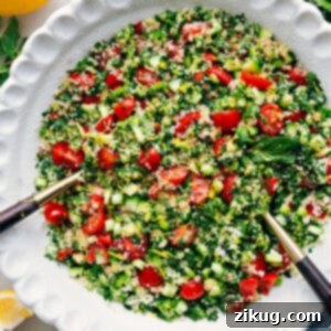 A vibrant bowl of fresh Tabouli salad, showcasing finely chopped herbs, tomatoes, and bulgur, perfectly dressed.