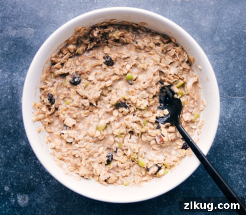 Loaded with oats, nuts, dried fruit, and plenty of apples -- it's delicious! Recipe via chelseasmessyapron #breakfast #best #quick #easy #simple #healthy #cleaneating #oats #bircher #muesli Image of a bowl of Bircher Muesli all mixed together