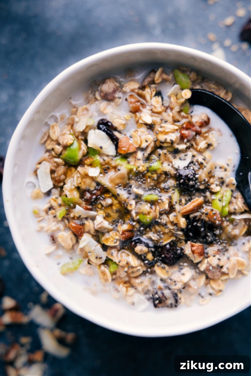 Bircher Muesli! Recipe via chelseasmessyapron #breakfast #best #quick #easy #simple #healthy #cleaneating #oats #bircher #muesli Up-close overhead image of the Bircher Muesli in a bowl with various toppings