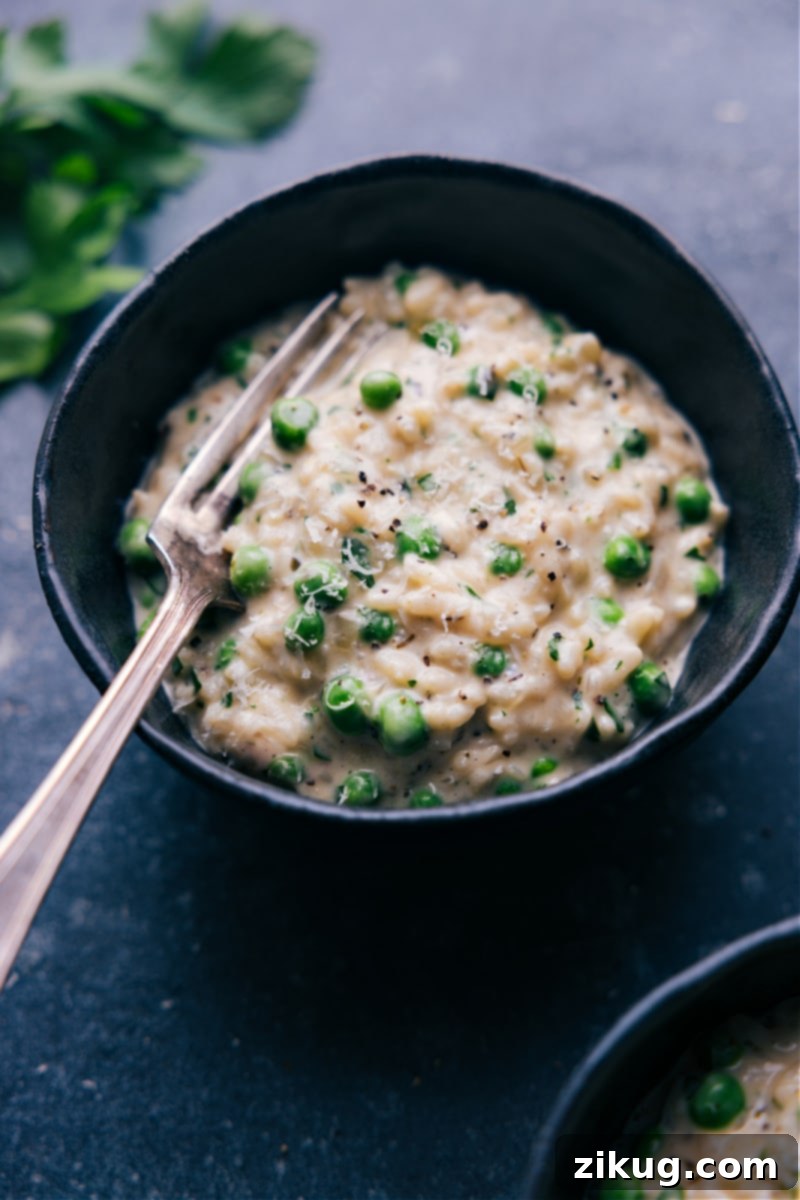 Effortless Velvety Instant Pot Risotto 2 Overhead view of a beautiful bowl of Instant Pot Risotto, garnished with fresh herbs and Parmesan cheese, showcasing its creamy texture.