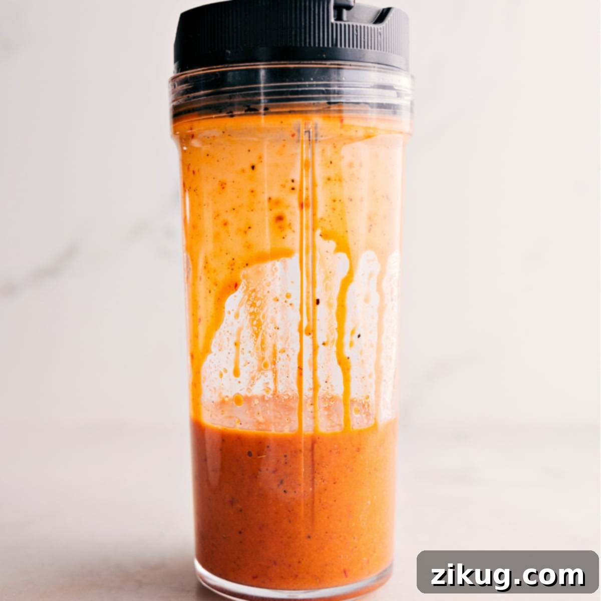 The Chipotle Vinaigrette blending smoothly in a high-speed blender, showing its creamy texture.