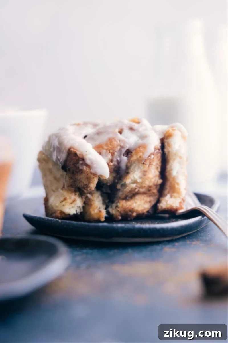 Enjoying the best easy cinnamon roll recipe. These rolls are fluffy, gooey, and topped with cream cheese frosting, perfect for breakfast or dessert.