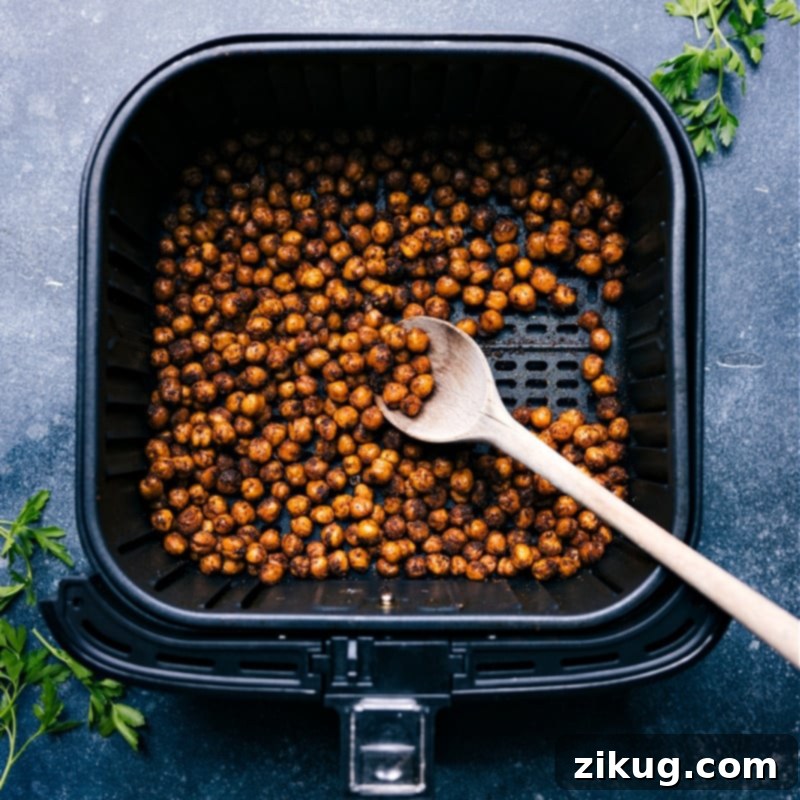 Master your air fryer: The Ultimate Guide to Crispy, Healthy Meals Overhead view of Roasted Chickpeas in the air fryer, symbolizing healthy, crispy air-fried food
