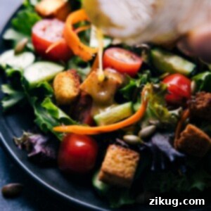 A simple yet elegant vinaigrette served in a clear glass bottle, ready for use.