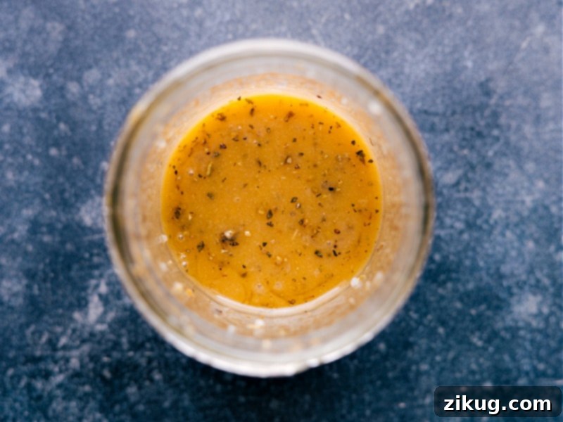 Craft the perfect vinaigrette effortlessly! This homemade dressing, brimming with fresh herbs and quality olive oil, is a game-changer for salads and beyond. #EasyRecipe #SaladDressing #HomemadeFood #HealthyRecipes Overhead view of homemade Vinaigrette in a stylish glass cruet, ready for serving.
