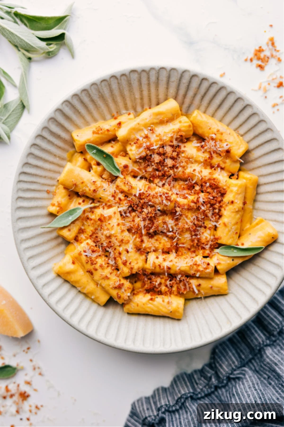 The Creamiest And Most Delicious Pumpkin Pasta Recipe for Fall A vibrant bowl of creamy pumpkin pasta garnished with golden crispy breadcrumbs and freshly grated Parmesan cheese, ready to be enjoyed.