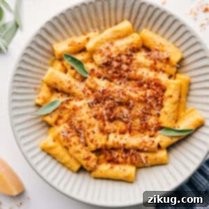 The finished ultra creamy pumpkin pasta dish, generously garnished with crispy sage breadcrumbs and ready to serve.