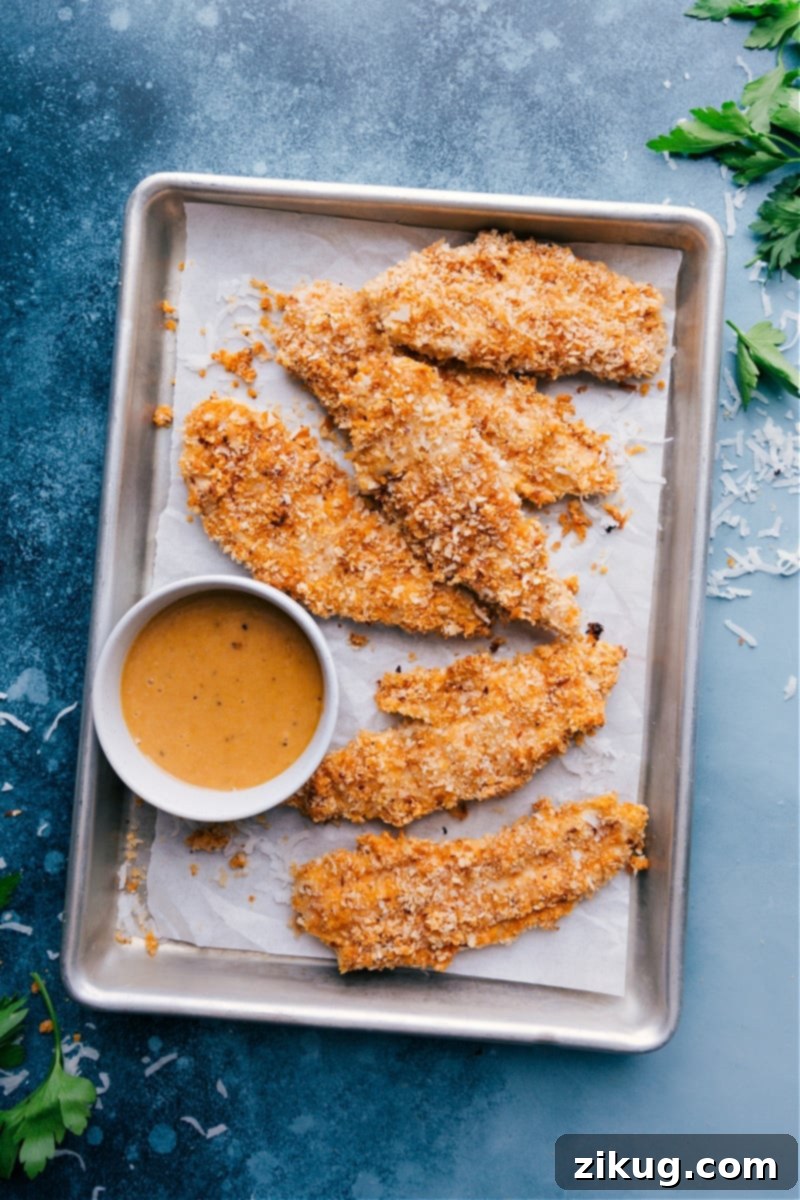 Ultra-crispy baked Coconut Chicken tenders with a quick five-ingredient honey-mustard dipping sauce. Recipe via ChelseasMessyApron #dinner #quick #easy #simple #oven #dippingsauce #chickentenders #coconut #chicken Coconut Chicken with honey-mustard dipping sauce