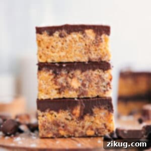 Finished Peanut Butter Rice Krispie Treats with chocolate topping and visible Reese's cups.