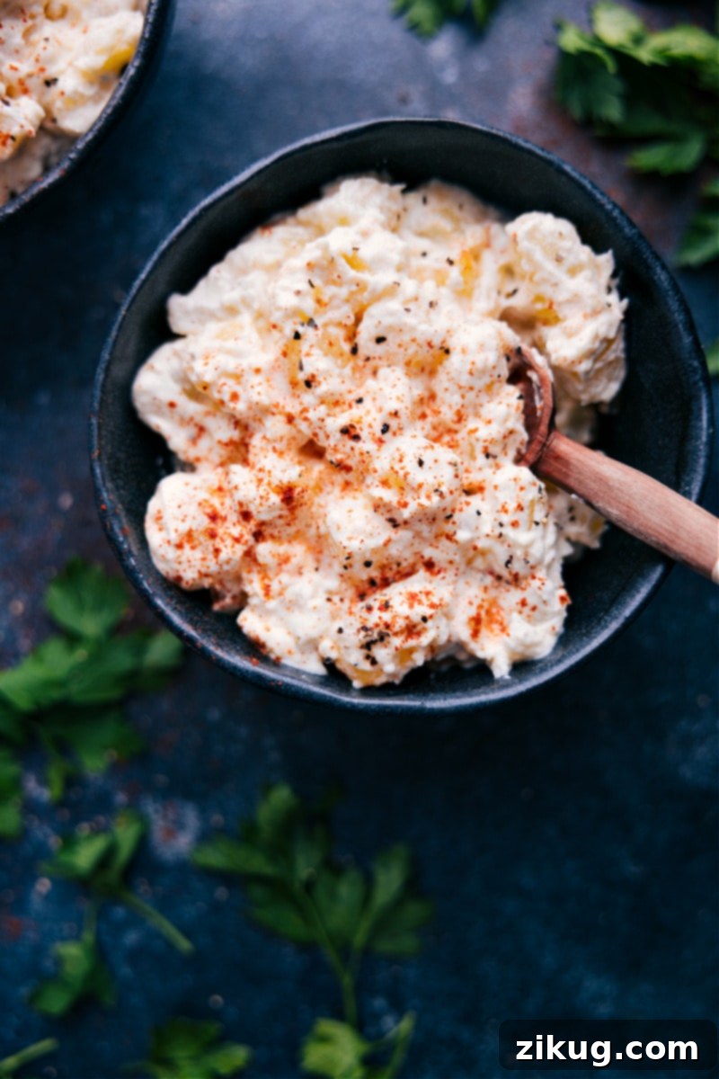 A serving bowl filled with creamy potatoes, beautifully sprinkled with paprika, ready to be enjoyed.