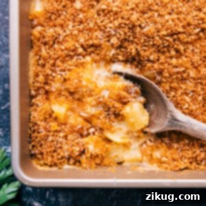 A close-up of a serving of freshly baked Cheesy Potatoes with a crispy golden topping.